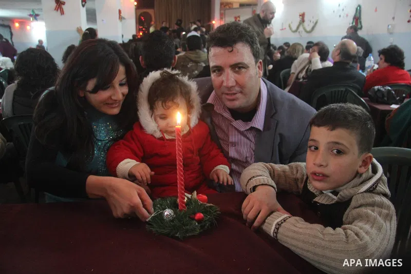 Palestinians Christian take part in the celebrations at a church of Deir Latin, during Christmas celebrations in Gaza city, on December 24, 2012. Photo by Ezz al-Zanoon