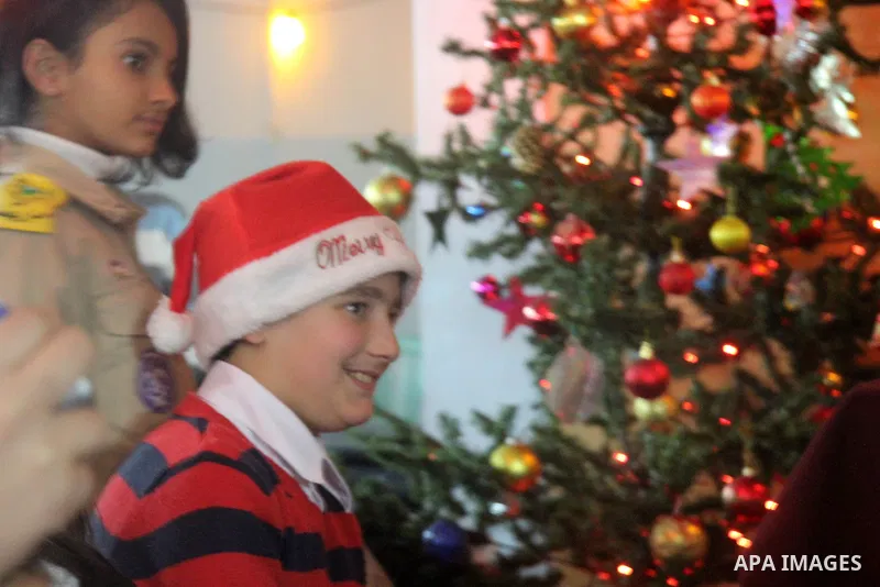 A Palestinian child dressed as Santa Claus during Christmas celebrations intside the Church of Deir Latin in Gaza city, on December 24, 2012. Photo by Ezz al-Zanoon