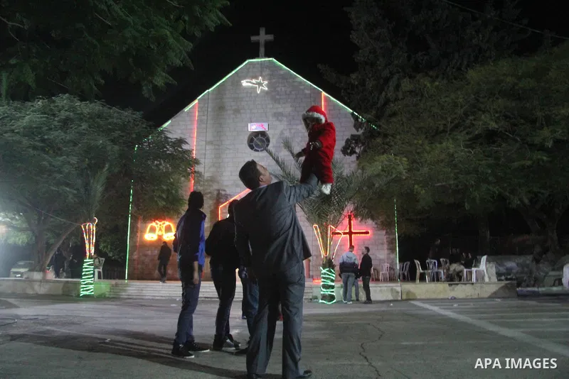 Palestinians Christian take part in the celebrations at a church of Deir Latin, during Christmas celebrations in Gaza city, on December 24, 2012. Photo by Ezz al-Zanoon
