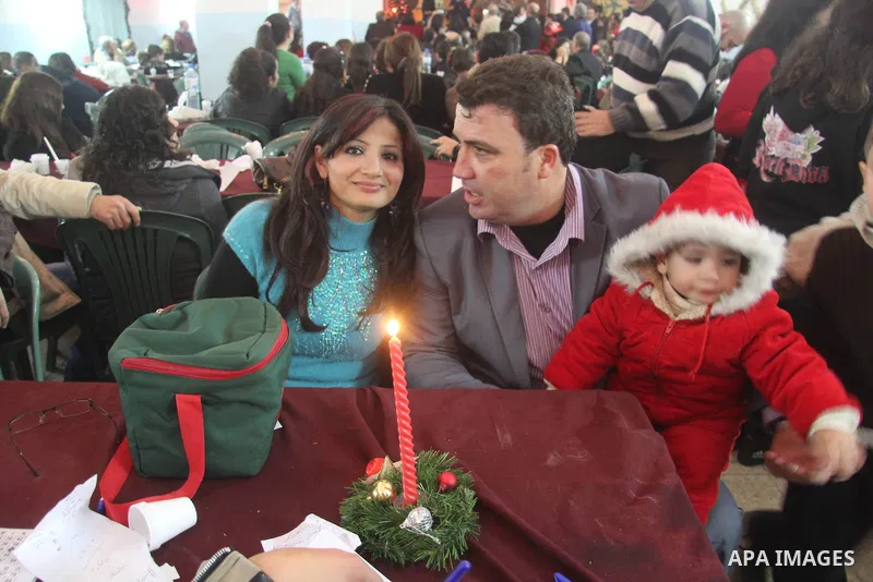 Palestinians Christian take part in the celebrations at a church of Deir Latin, during Christmas celebrations in Gaza city, on December 24, 2012. Photo by Ezz al-Zanoon
