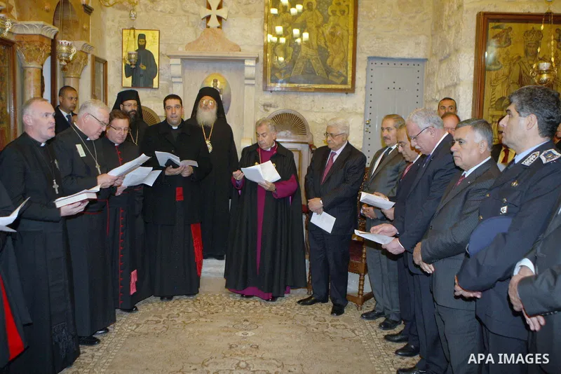 Palestinian President Mahmoud Abbas (Abu Mazen) participates in the Christmas Mass for the Anglican community, in the church of Saint Grace Orthodox Church of the Nativity, in the West Bank city of Bethlehem, on Dec. 24,...
