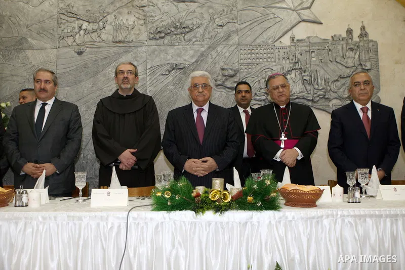 Palestinian President Mahmoud Abbas (Abu Mazen) participatesin the 'dinner Birth' in the Franciscan monastery, in the West Bank city of Bethlehem, on Dec. 24, 2012. Photo by Thaer Ganaim