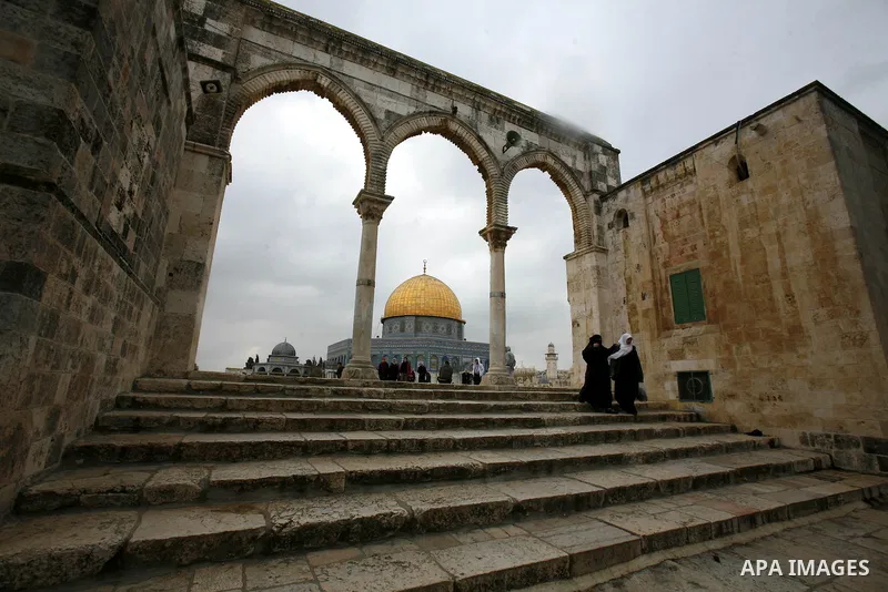Palestinian worshippers walk in front of the Dome of the Rock mosque following a prayer at al-Aqsa mosque, Islam's third holiest site, on December 25, 2012, in the old city of Jerusalem. Photo by Mahfouz Abu Turk