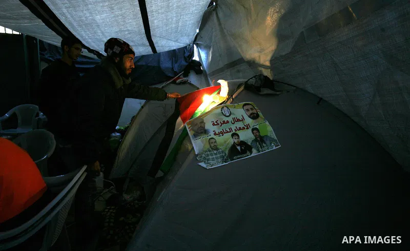 Palestinian youths sit in a tent during a hunger strike sit-in in Jerusalem. 25 December 2012, in solidarity with hunger-striking detainees held by Israel to demand their release from detention without trial. Photo by Ma...