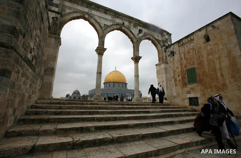Palestinian worshippers walk in front of the Dome of the Rock mosque following a prayer at al-Aqsa mosque, Islam's third holiest site, on December 25, 2012, in the old city of Jerusalem. Photo by Mahfouz Abu Turk