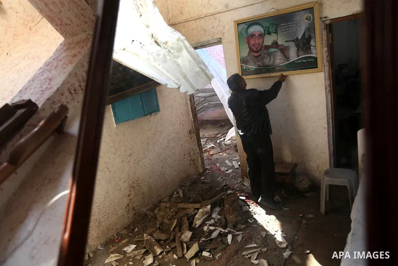 A Palestinian man puts a portrait of his killed son on the wall at his bombed house, marking the 4 th anniversary of his death during the Israel-Gaza war, in Gaza City, on Dec. 26, 2012. The three-week offensive dramatic...
