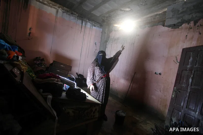 A Palestinian inspect damages in their house damaged in an Israeli air strike, marking the 4 th anniversary of the Israel-Gaza war, in Gaza City, on Dec. 26, 2012. The three-week offensive dramatically reduced the number...