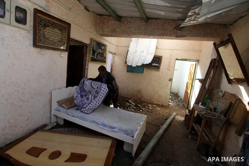 A Palestinian inspect damages in their house damaged in an Israeli air strike, marking the 4 th anniversary of the Israel-Gaza war, in Gaza City, on Dec. 26, 2012. The three-week offensive dramatically reduced the number...