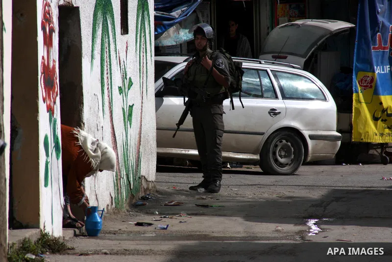 An Israeli soldier stands guard during a search carried out by Israeli soldiers after they raided the village of Urif, near Nablus, West Bank, 27 December 2012. Israeli soldiers raided the village after clashes occurred...