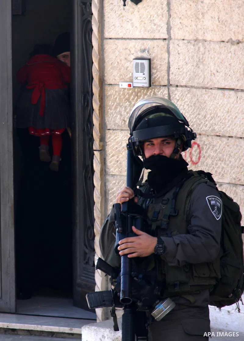 An Israeli soldier stands guard during a search carried out by Israeli soldiers after they raided the village of Urif, near Nablus, West Bank, 27 December 2012. Israeli soldiers raided the village after clashes occurred...