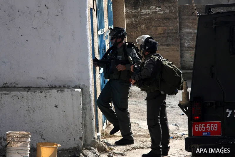 Israeli soldiers enter a Palestinian house during a search carried out by Israeli soldiers after they raided the village of Urif, near Nablus, West Bank, 27 December 2012. Israeli soldiers raided the village after clashe...