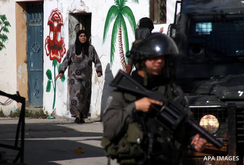 Israeli soldiers stand guard during a search carried out by Israeli soldiers after they raided the village of Urif, near Nablus, West Bank, 27 December 2012. Israeli soldiers raided the village after clashes occurred bet...