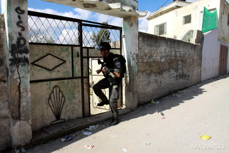 An Israeli soldier enters a Palestinian house during a search carried out by Israeli soldiers after they raided the village of Urif, near Nablus, West Bank, 27 December 2012. Israeli soldiers raided the village after cla...