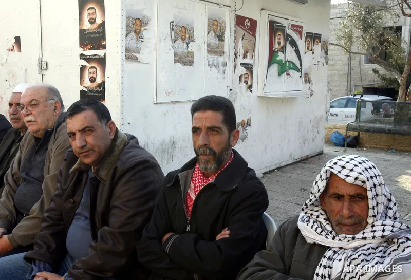 Palestinians gather in front of the Red Cross offices during sit-in outside the Red Cross offices to show solidarity with Palestinian prisoner Samer Issawi who held in an Israeli jail and on hunger strike since August 1...
