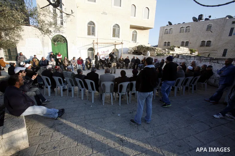 Palestinians gather in front of the Red Cross offices during sit-in outside the Red Cross offices to show solidarity with Palestinian prisoner Samer Issawi who held in an Israeli jail and on hunger strike since August 1...