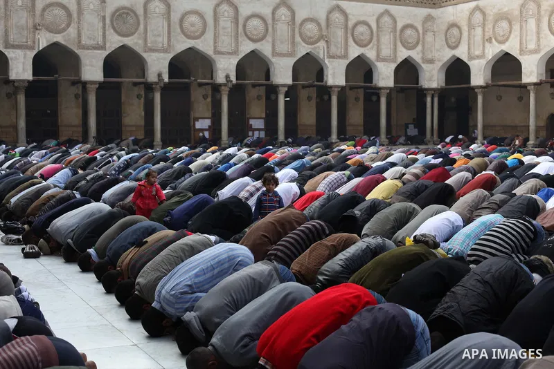 People perform Friday prayers, led by Egyptian cleric Sheikh Yusuf al-Qaradawi, chairman of the International Union of Muslim Scholars, before a protest against Syrian President Bashar al-Assad, at Al Azhar mosque in old...