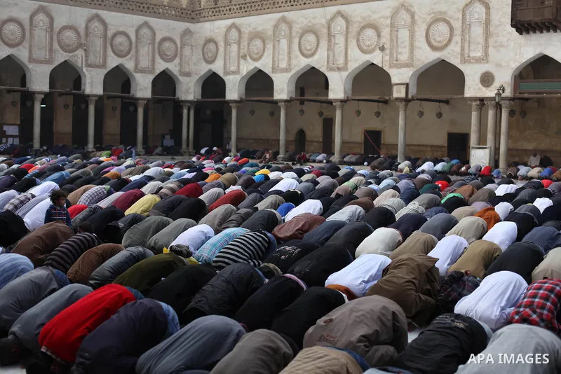 People perform Friday prayers, led by Egyptian cleric Sheikh Yusuf al-Qaradawi, chairman of the International Union of Muslim Scholars, before a protest against Syrian President Bashar al-Assad, at Al Azhar mosque in old...