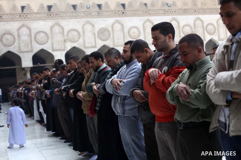 People perform Friday prayers, led by Egyptian cleric Sheikh Yusuf al-Qaradawi, chairman of the International Union of Muslim Scholars, before a protest against Syrian President Bashar al-Assad, at Al Azhar mosque in old...