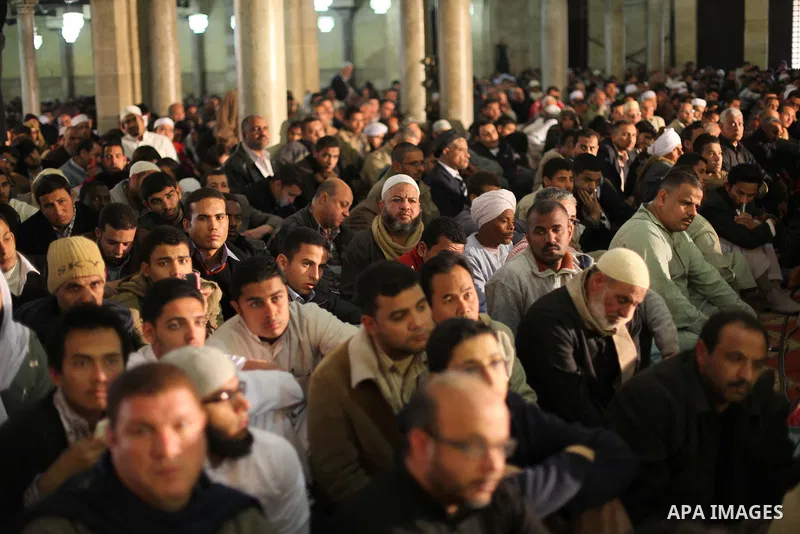 People perform Friday prayers, led by Egyptian cleric Sheikh Yusuf al-Qaradawi, chairman of the International Union of Muslim Scholars, before a protest against Syrian President Bashar al-Assad, at Al Azhar mosque in old...