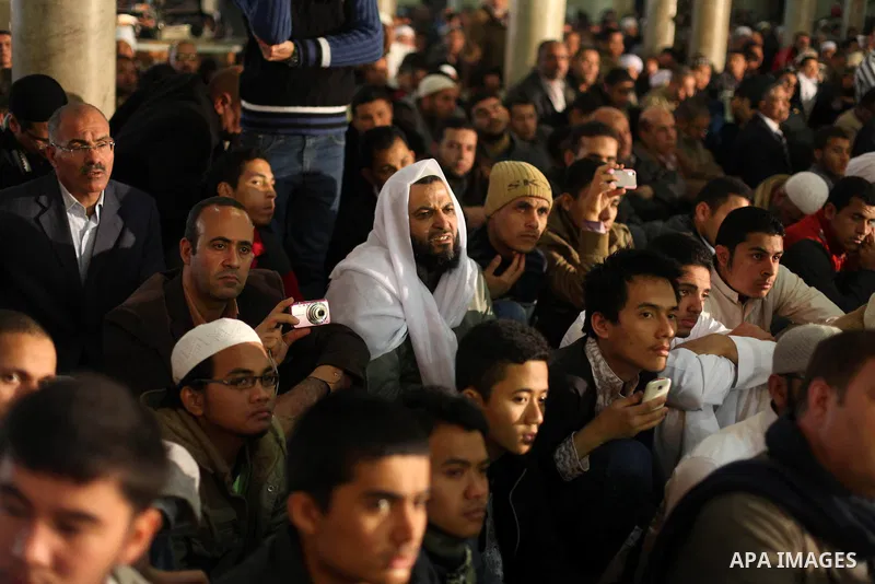 People perform Friday prayers, led by Egyptian cleric Sheikh Yusuf al-Qaradawi, chairman of the International Union of Muslim Scholars, before a protest against Syrian President Bashar al-Assad, at Al Azhar mosque in old...