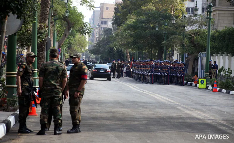 Egyptian riot police stand guard outside the Shura Council, the upper house of parliament where the Constituent Assembly drafted the country's new constitution, as protesters against Egypt's President Mohamed Morsi chant...