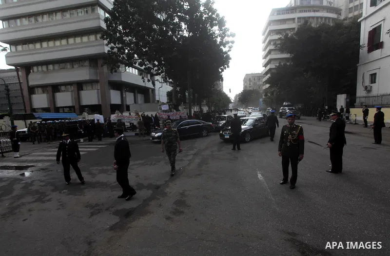 Egyptian riot police stand guard outside the Shura Council, the upper house of parliament where the Constituent Assembly drafted the country's new constitution, as protesters against Egypt's President Mohamed Morsi chant...