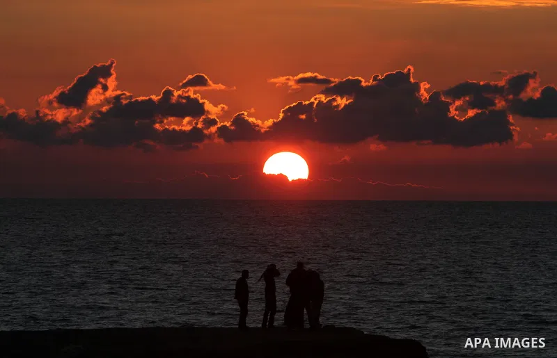 Palestinian fishers prepare to throw their trawl in the sea during sunset on the beach of Gaza city,on December 29, 2012. Photo by Majdi Fathi
