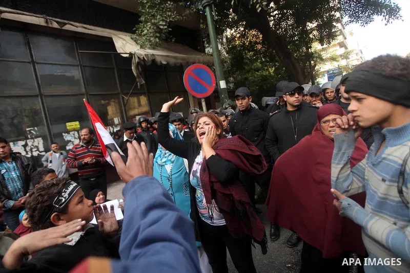 Egyptians women protest against the police officers near the Shura Council, the upper house of parliament where the Constituent Assembly drafted the country's new constitution, as protesters against Egypt's President Moh...