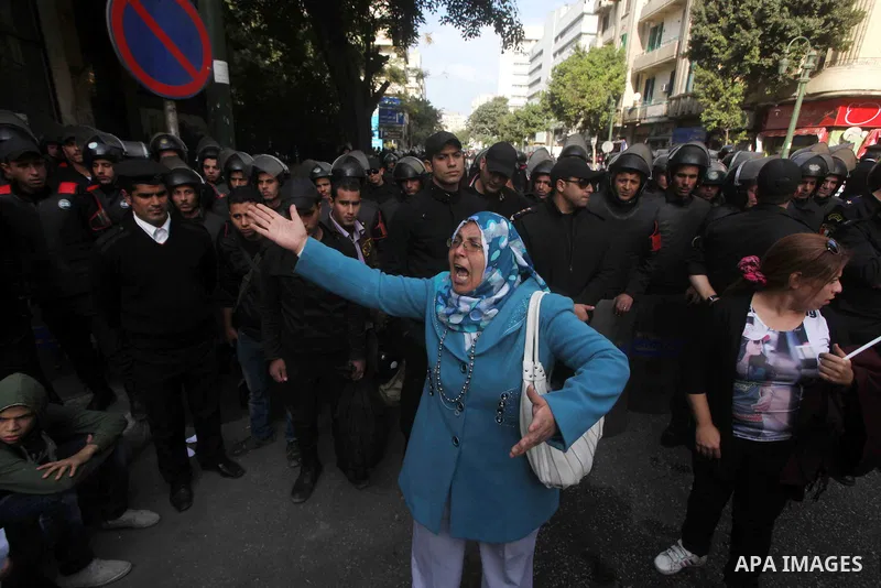Egyptians women protest against the police officers near the Shura Council, the upper house of parliament where the Constituent Assembly drafted the country's new constitution, as protesters against Egypt's President Moh...