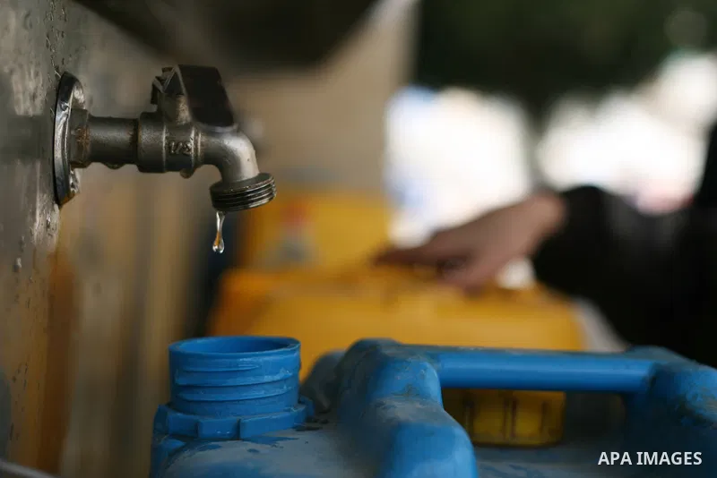 Palestinian children fill plastic bottles with drinking water in Rafah camp southern Gaza Strip, on Dec. 30, 2012. The residents of the Gaza strip suffer from lack of potable water, Israel continues to tighten its blocka...