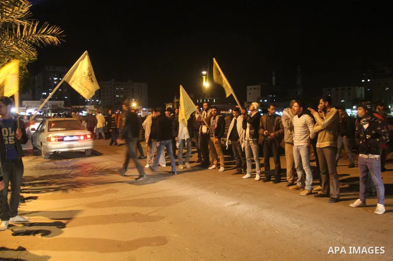 Palestinian supporters of Fatah movement hold the party's flags during a rally in Gaza city on December 30, 2012. The Gaza branch of Palestinian president Mahmud Abbas's Fatah party said on Friday it will mark its annive...