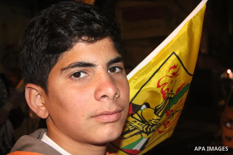 A Palestinian supporter of Fatah movement holds the party's flag during a rally in Gaza city on December 30, 2012. The Gaza branch of Palestinian president Mahmud Abbas's Fatah party said on Friday it will mark its anniv...