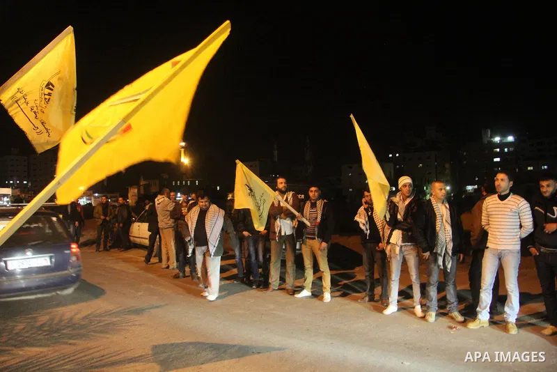 Palestinian supporters of Fatah movement hold the party's flags during a rally in Gaza city on December 30, 2012. The Gaza branch of Palestinian president Mahmud Abbas's Fatah party said on Friday it will mark its annive...