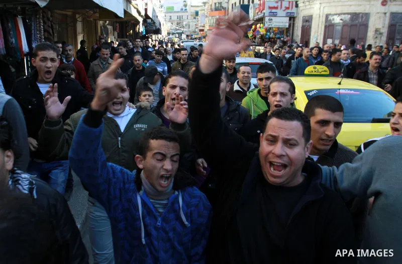 Palestinians shout slogans during a demonstration against the economic situation and against Palestinian prime minister Salam Fayyad in the northern West Bank city of Nablus on December 31, 2012. The protest came after F...