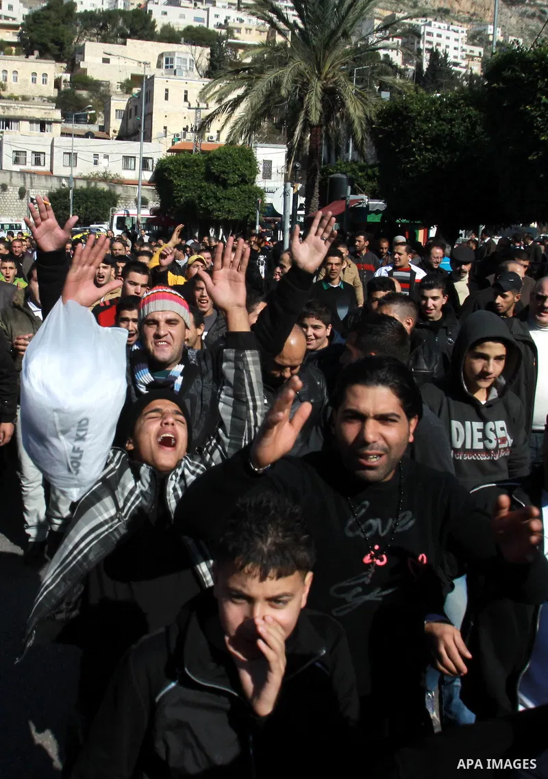 Palestinians shout slogans during a demonstration against the economic situation and against Palestinian prime minister Salam Fayyad in the northern West Bank city of Nablus on December 31, 2012. The protest came after F...
