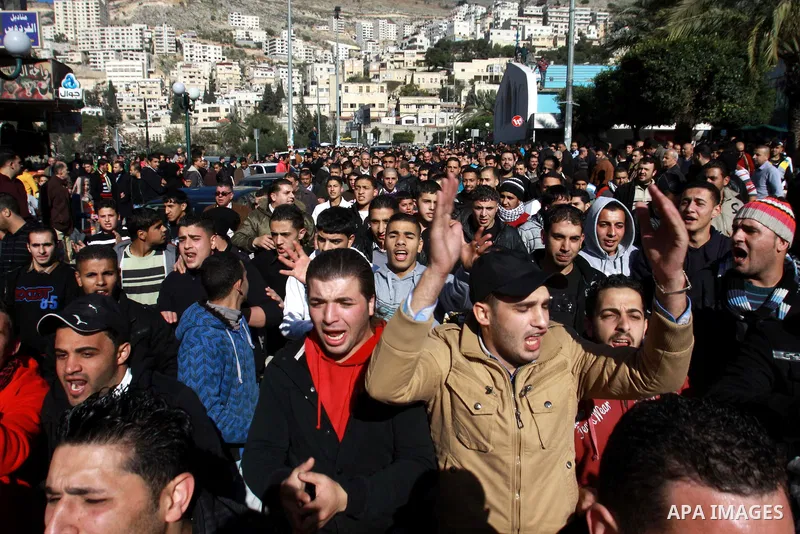 Palestinians shout slogans during a demonstration against the economic situation and against Palestinian prime minister Salam Fayyad in the northern West Bank city of Nablus on December 31, 2012. The protest came after F...
