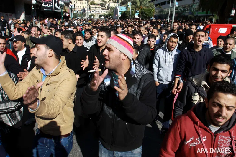 Palestinians shout slogans during a demonstration against the economic situation and against Palestinian prime minister Salam Fayyad in the northern West Bank city of Nablus on December 31, 2012. The protest came after F...