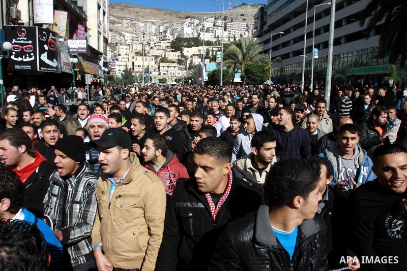 Palestinians shout slogans during a demonstration against the economic situation and against Palestinian prime minister Salam Fayyad in the northern West Bank city of Nablus on December 31, 2012. The protest came after F...