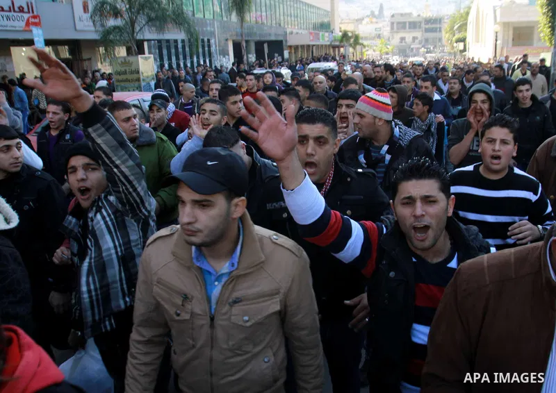 Palestinians shout slogans during a demonstration against the economic situation and against Palestinian prime minister Salam Fayyad in the northern West Bank city of Nablus on December 31, 2012. The protest came after F...