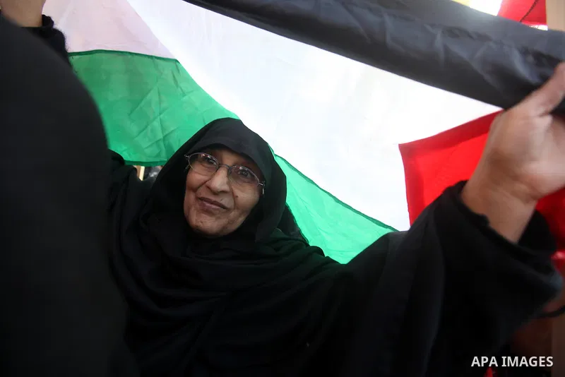 Palestinians hold pictures of prisoners held in the Israeli jails during a rally in Gaza city on December 31, 2012. in solidarity with hunger-striking detainees held by Israel to demand their release from detention witho...