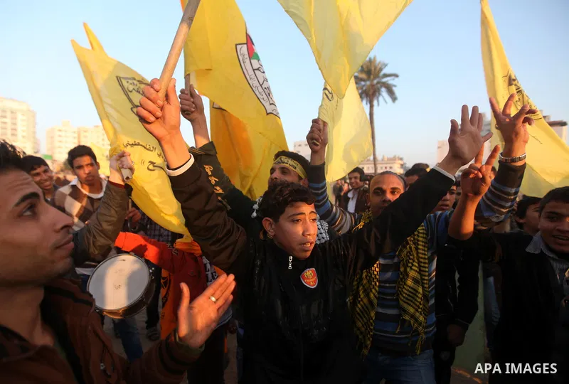 Palestinian supporters of Fatah movement hold the party's flags during a rally in Gaza city on December 31, 2012. The Gaza branch of Palestinian president Mahmud Abbas's Fatah party said on Friday it will mark its annive...