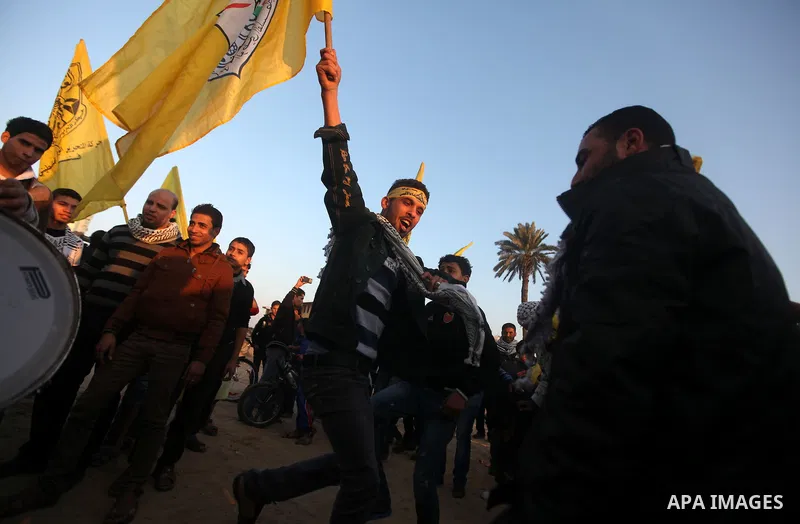 Palestinian supporters of Fatah movement hold the party's flags during a rally in Gaza city on December 31, 2012. The Gaza branch of Palestinian president Mahmud Abbas's Fatah party said on Friday it will mark its annive...