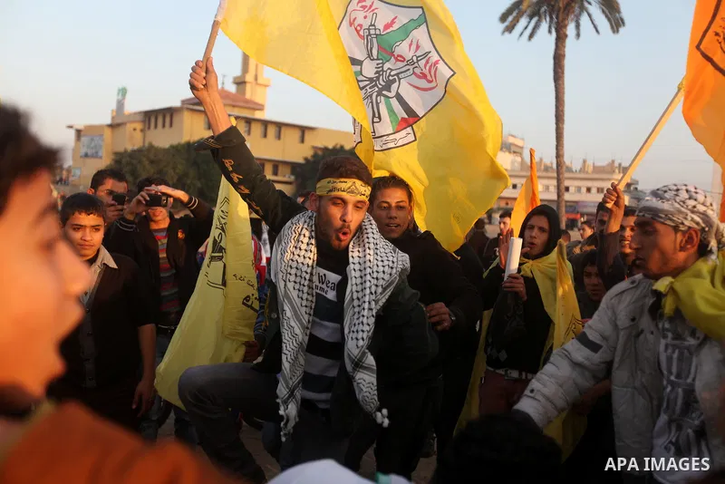 Palestinian supporters of Fatah movement hold the party's flags during a rally in Gaza city on December 31, 2012. The Gaza branch of Palestinian president Mahmud Abbas's Fatah party said on Friday it will mark its annive...