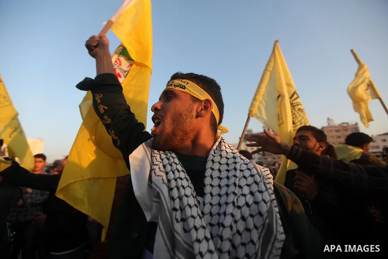 Palestinian supporters of Fatah movement hold the party's flags during a rally in Gaza city on December 31, 2012. The Gaza branch of Palestinian president Mahmud Abbas's Fatah party said on Friday it will mark its annive...