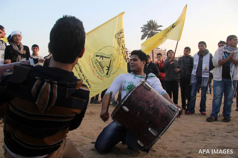 Palestinian supporters of Fatah movement hold the party's flags during a rally in Gaza city on December 31, 2012. The Gaza branch of Palestinian president Mahmud Abbas's Fatah party said on Friday it will mark its annive...