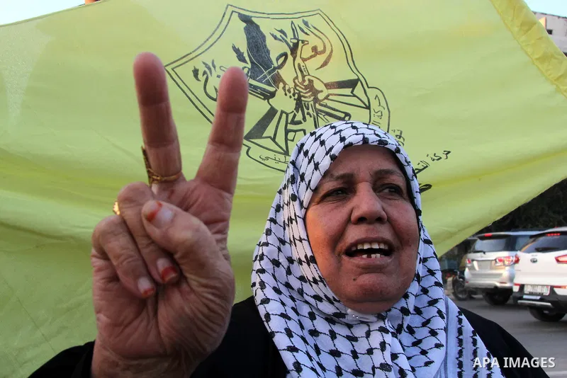 A Palestinian woman marks victory sign during a rally in Gaza city on December 31, 2012. The Gaza branch of Palestinian president Mahmud Abbas's Fatah party said on Friday it will mark its anniversary in the Hamas-ruled...