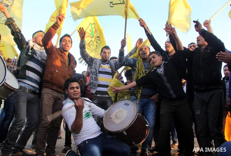 Palestinian supporters of Fatah movement hold the party's flags during a rally in Gaza city on December 31, 2012. The Gaza branch of Palestinian president Mahmud Abbas's Fatah party said on Friday it will mark its annive...