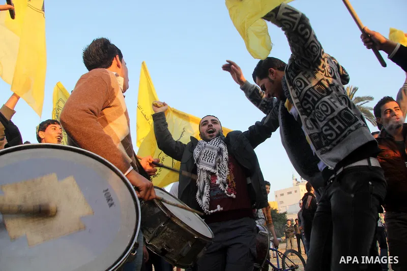 Palestinian supporters of Fatah movement hold the party's flags during a rally in Gaza city on December 31, 2012. The Gaza branch of Palestinian president Mahmud Abbas's Fatah party said on Friday it will mark its annive...