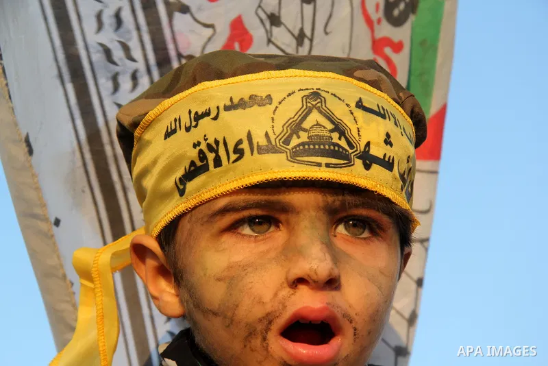 A Palestinian child wears a headband of Fatah movement during a rally in Gaza city on December 31, 2012. The Gaza branch of Palestinian president Mahmud Abbas's Fatah party said on Friday it will mark its anniversary in...
