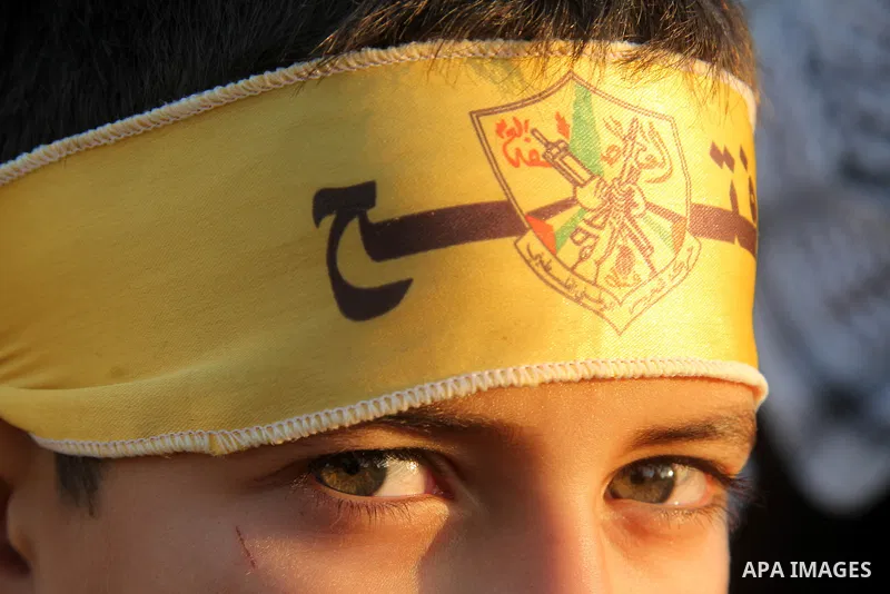 A Palestinian child wears a headband of Fatah movement during a rally in Gaza city on December 31, 2012. The Gaza branch of Palestinian president Mahmud Abbas's Fatah party said on Friday it will mark its anniversary in...